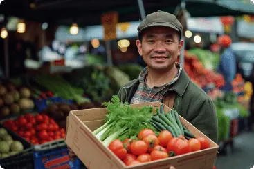 A smiling produce trader at his market stall